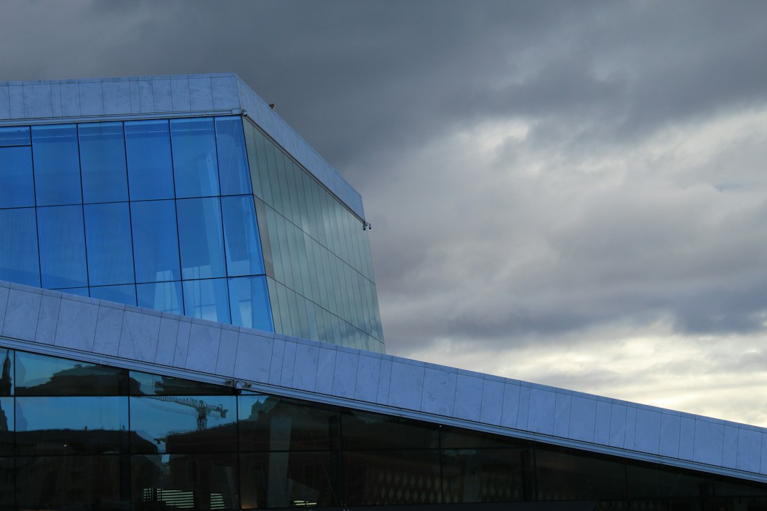Glass architecture reflecting the sky in Oslo